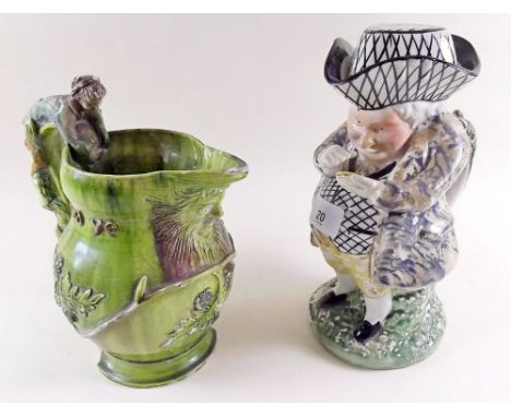 A large Victorian toby jug with black and white hatched hat and waistcoat, 25cm and a green pottery mask jug a/f