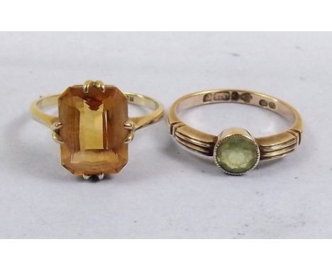 A 9ct gold peridot ring and a 9ct gold yellow stone ring 