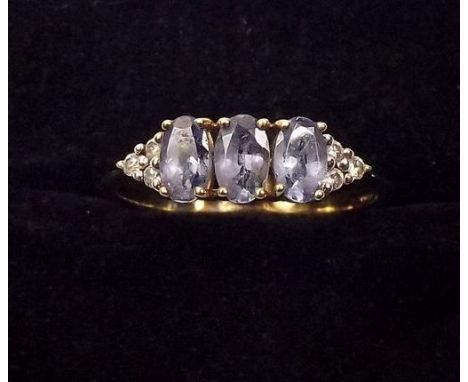 A 9ct gold ring set 3 tanzanites on chip diamond shoulders 