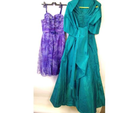 A green satin ball gown with stiffened underskirt and a matching stole and a blue floral voile short boned evening dress with