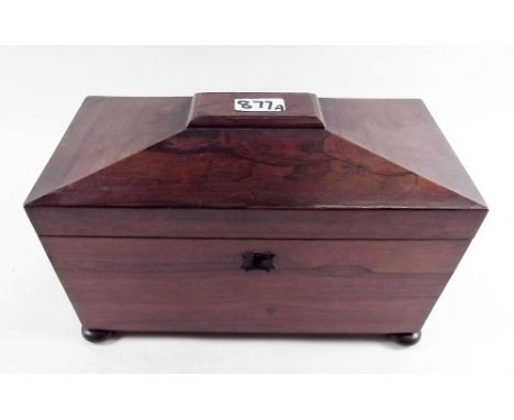 An early 19th century rosewood sarcophagus form tea caddy with two fitted caddies within