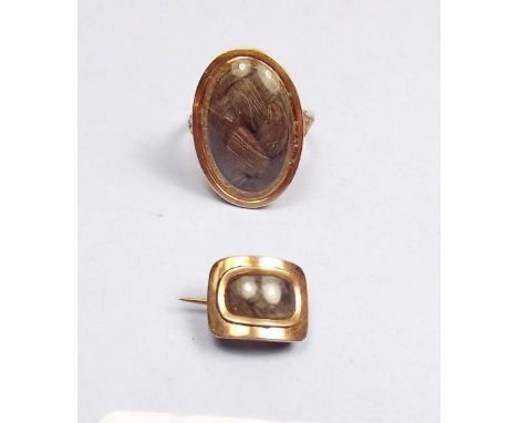 A Victorian yellow metal oval mourning ring with woven hair panel and a small mourning brooch 