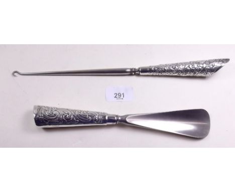 A silver handled button hook by Barrett and Son and a white metal shoe horn 