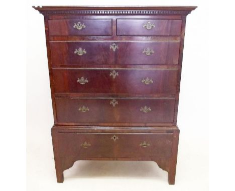 A Georgian mahogany chest of two short and three long drawers on stand with drawer all raised on  bracket supports 
