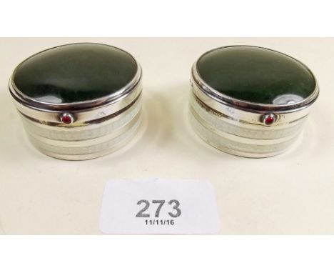 A pair of silver circular stone set dressing table boxes with ruby button and banded enamel decoration to sides Birmingham 19