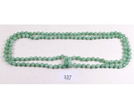 A long 'jade' bead necklace 