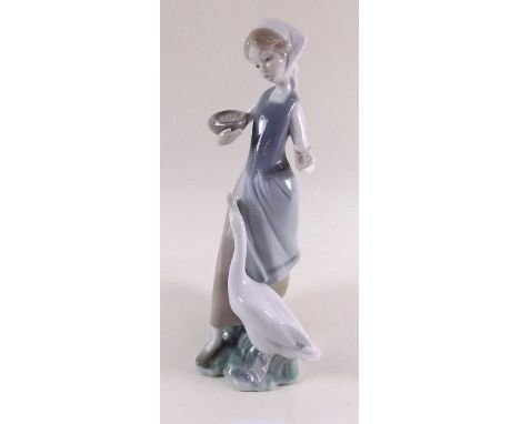 A Lladro group girl with goose 