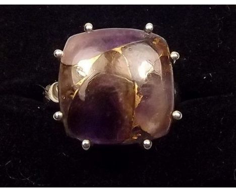 A silver ring set copper Mojave amethyst 