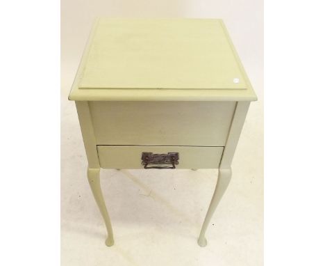 A vintage painted work table with rise top