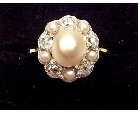 An 18ct gold ring set untested pearl within pearl and diamond surround 