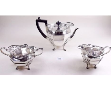 A silver tea set comprising teapot, sugar bowl and milk jug all with pierced rim decoration and paw feet, London 1912, 35ozs 