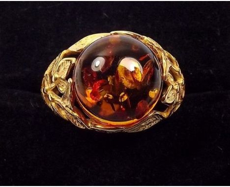 A silver gilt amber ring with foliate shoulders 
