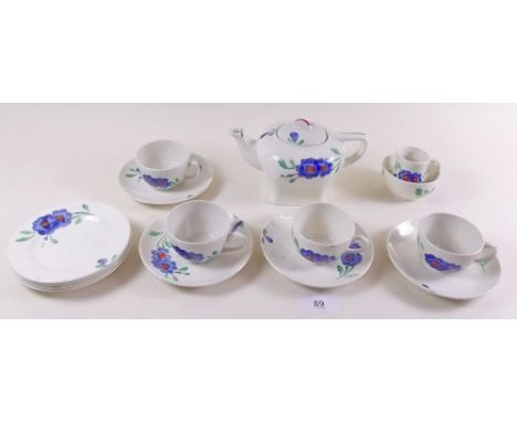 A 1930's childs floral painted tea set comprising: teapot, four cups and saucers, milk, sugar and four tea plates