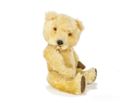 A Chiltern Hugmee Teddy Bear, circa 1958, with bright golden mohair, orange and black plastic eyes, black plastic nose, swive