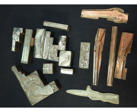 Three boxes containing sixteen 19th C metal gun and military related printing blocks for pistols, rifles, ammunition etc 