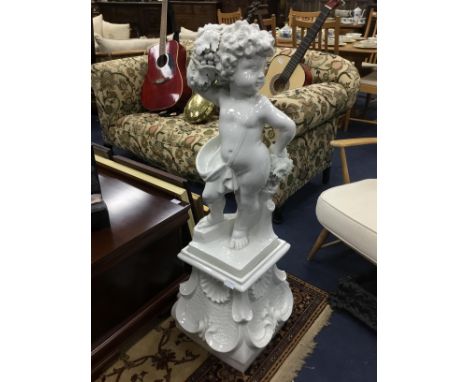 CERAMIC FIGURE OF A CHERUB, modelled holding fruit, on a square base, 110cm high