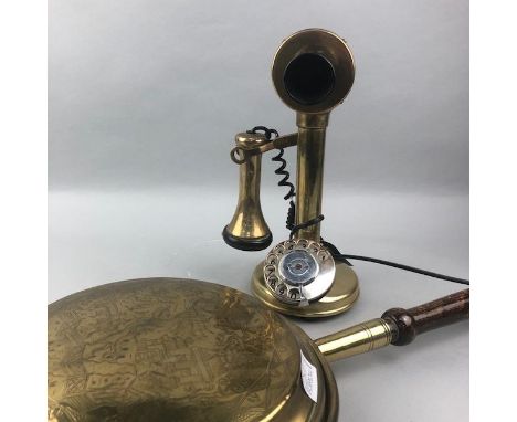 BRASS CANDLESTICK TELEPHONE, 33cm high, along with a brass bed warming pan (2)