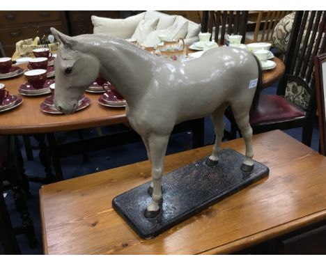 PAINTED WOOD MODEL OF A HORSE, on a wood base, 57cm long