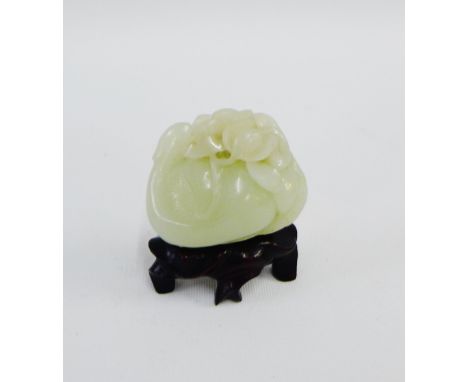 Small carved jade of nuts and flowers, on a hardwood stand, height overall 6cm 