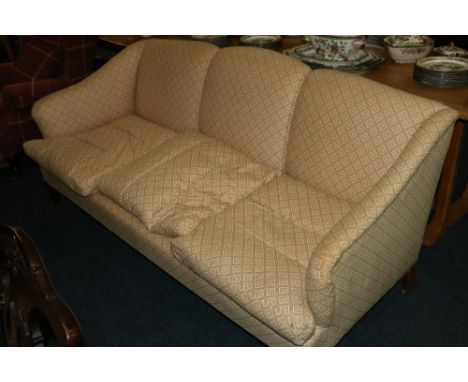 Whytock and Reid mahogany three seater sofa raised on tapering supports capped with brass castors, upholstered in Whytock and