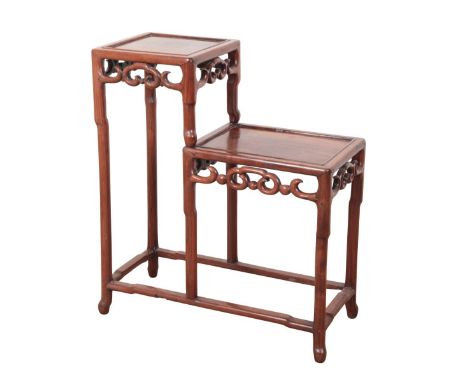 A CHINESE 'HONGMU' STEPPED STAND Qing dynasty, 19th century, with two tiers with open scroll frieze, on turned legs joined by