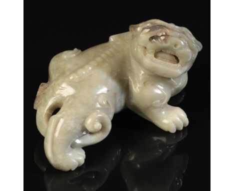 A CHINESE CELADON JADE BUDDHISTIC LION Qing or later, the beast with a well-defined spine and an open mouth bearing teeth and