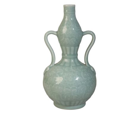 A FINE CHINESE CELADON DOUBLE BALUSTER VASE with finely carved decoration of lotus flowers and feathery leaves, and two scrol