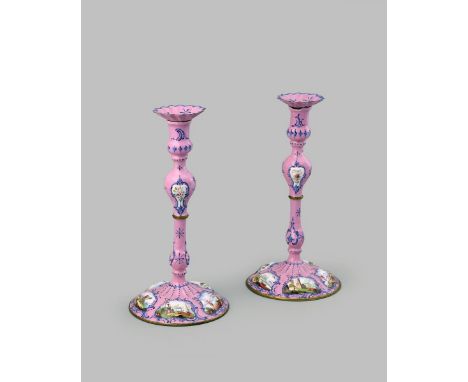 A large pair of Staffordshire enamel candlesticks and detachable sconces, c.1770, decorated with panels of figures in harbour