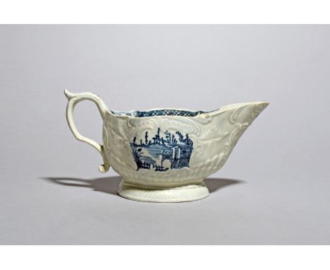 A James Pennington (Liverpool) blue and white sauceboat, c.1765-70, moulded with rococo scroll panels containing painted pago