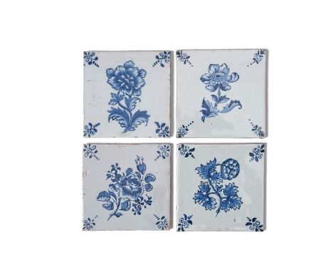 Four Lambeth delftware botanical tiles, c.1760-80, finely painted in blue, each with a single flower stem including peony, ra