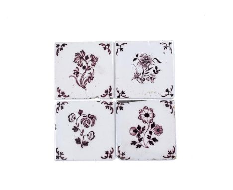 Four delftware tiles, c.1755-75, probably Liverpool, each painted in manganese with a curved flower stem within feathery corn
