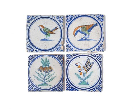 Four Delft tiles, late 17th century, two painted with birds in blue, green, ochre and manganese, within blue circular panels,