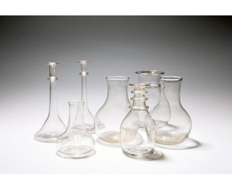 Seven glass carafes or small vases, late 18th/19th century, two of plain bottle shape, one with a neck ring and everted rim, 