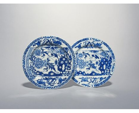 A pair of Bow blue and white plates, c.1750-55, painted with the Broken Scroll pattern, the scroll depicting flowering peony 