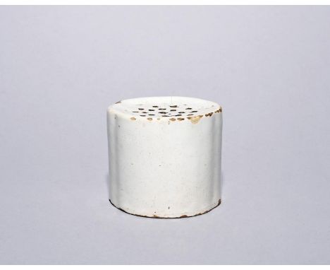 A delftware pounce pot, mid 18th century, the slightly lobed form with a gently recessed top set with an arrangement of small