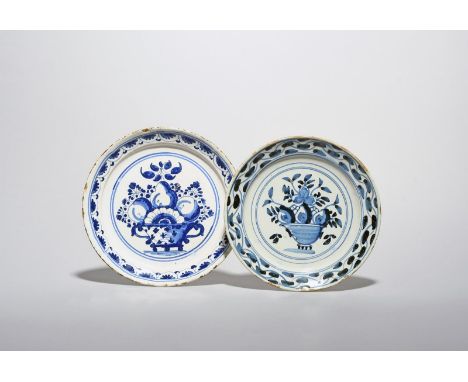 A small delftware plate, 18th century, possibly London, painted in blue with a footed bowl of fruit and flowers, the rim with