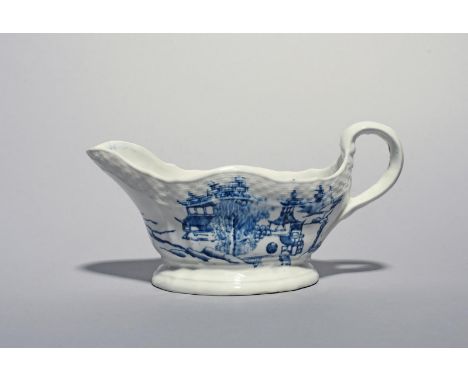 A large English porcelain blue and white sauceboat, c.1770-80, attributed to Wirksworth, painted to each side with differing 