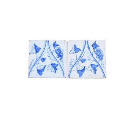 An unusual pair of Liverpool delftware tiles, c.1770, painted in blue with a double grapevine stem issuing leaves and grapes,