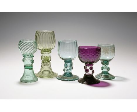 Four moulded glass roemers, 18th/19th century, one of amethyst glass with a hammered bowl over a clear stem applied with rasp