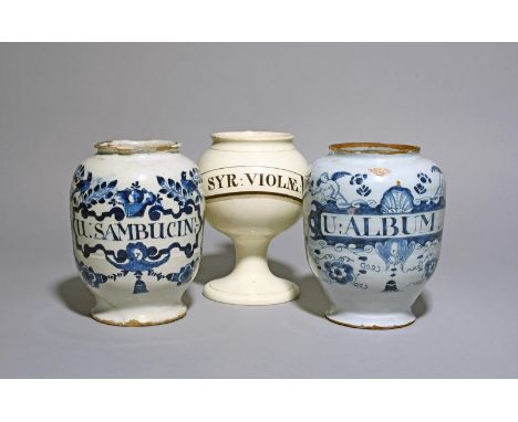 Two English delftware drug jars, c.1700-40, painted in blue, one with a shaped cartouche inscribed 'U: SAMBUCIN' beneath a ba