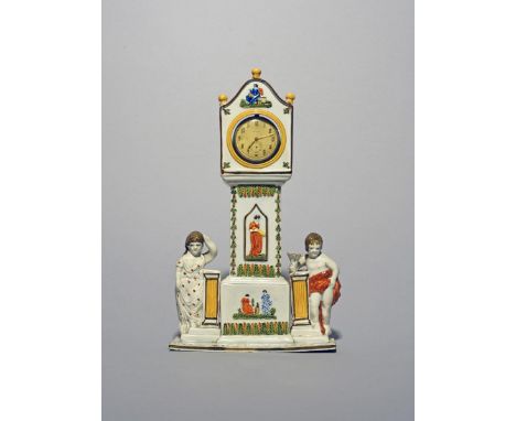 A rare Pratt ware watch stand, c.1800, modelled as a longcase clock flanked by a boy and girl, the case moulded and enamelled