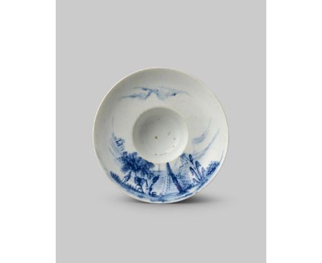 A rare Longton Hall blue and white saucer, c.1754-58, with an unusual deep trembleuse well, the concave rim painted with the 