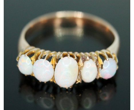 A five stone opal ring, band unmarked 2.16g, size K.  Condition - one stone chipped and another glued into setting, otherwise