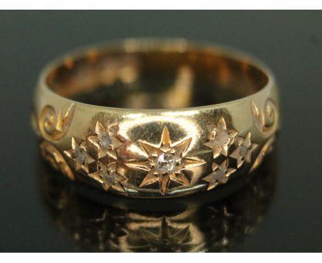 An Edwardian diamond cluster ring, six diamonds set with stars, scroll shoulders, sponsor's mark 'S.U', Chester 1904, gross w