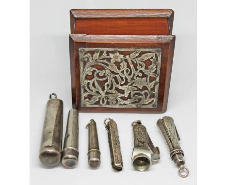 A hallmarked silver mounted wooden box and contents comprising hallmarked silver including three cheroot holders, a cigar pri