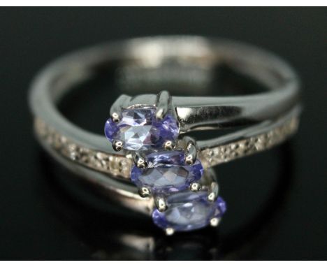 A hallmarked 9ct white gold tanzanite and diamond ring, gross wt. 2.45g, size P.  Condition - general wear.