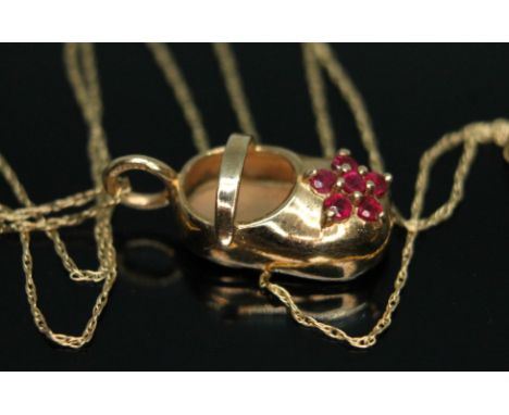 A novelty pendant modelled as a clog and set with a cluster of rubies, marked '10K', loop hallmarked 9ct gold, length 21mm, o