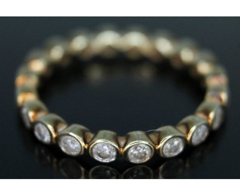 A 9ct gold diamond eternity ring, formed from twenty bezel set diamonds weighing approx. 0.02 carats each, total approx. diam