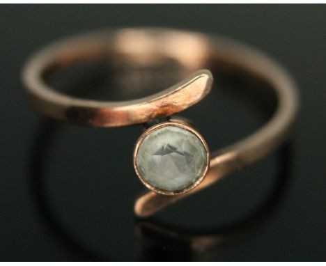 A dress ring set with a round cut aquamarine, band marked '9ct', gross wt. 1.07g, size L.  