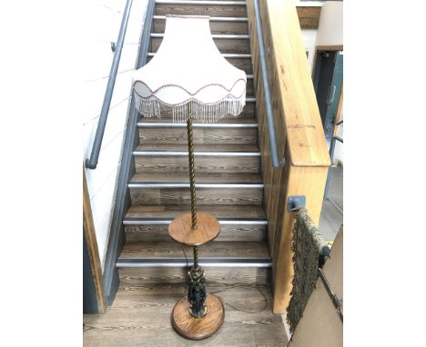 A turned brass and oak smokers lamp having twist brass stem, round oak center table above a scrolled and fluted pedestal with